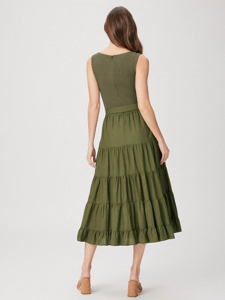 Woman facing away from the camera modeling a Paige Samosa Dress in Dark Olive with tiered ruffles.