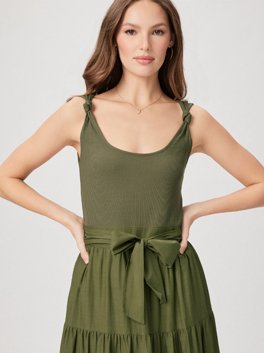 Woman wearing a Paige Samosa Dress in Dark Olive with tie straps and a waist sash.