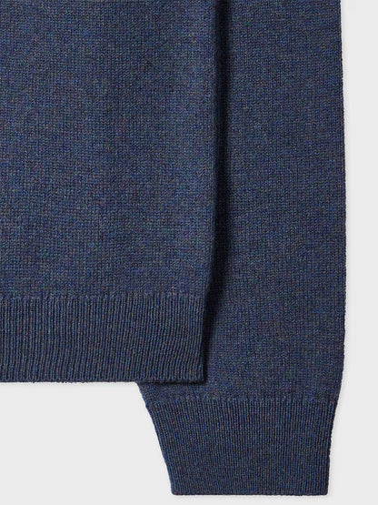 Close-up of the Paul Smith Indigo Merino Wool Crew Neck Sweater in soft knit, showcasing its ribbed hem and cuffs against a plain background.