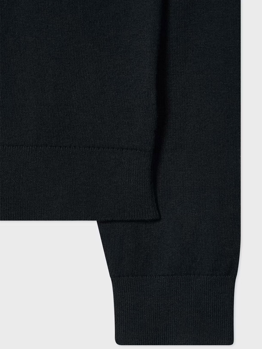 Close-up of the Paul Smith Merino Wool Sports Stripe Half Zip in black, featuring its ribbed hem and sleeve cuff details against a light background.