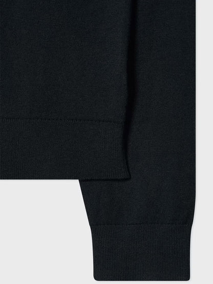 Close-up of the Paul Smith Merino Wool Sports Stripe Half Zip in black, featuring its ribbed hem and sleeve cuff details against a light background.