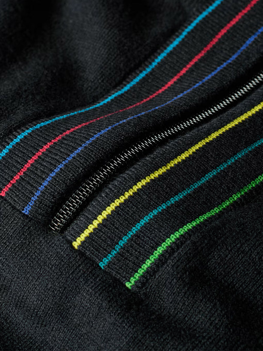 Close-up of the Paul Smith Merino Wool Sports Stripe Half Zip in Black, showcasing colorful parallel stripes in blue, red, yellow, and green.