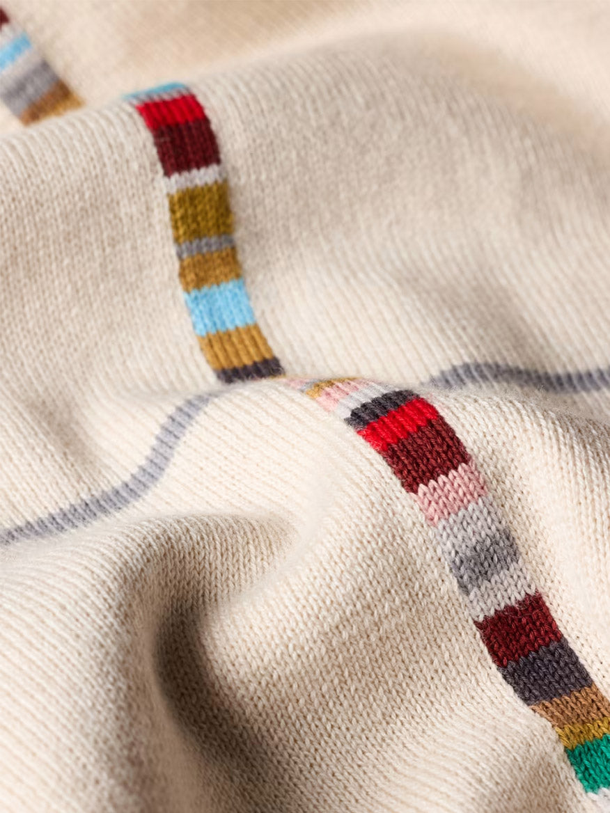 A close-up of the Paul Smith Signature Stripe Check Knitted Cotton Polo Shirt in ecru, crafted from organic cotton and featuring signature stripes in red, blue, green, and gray.