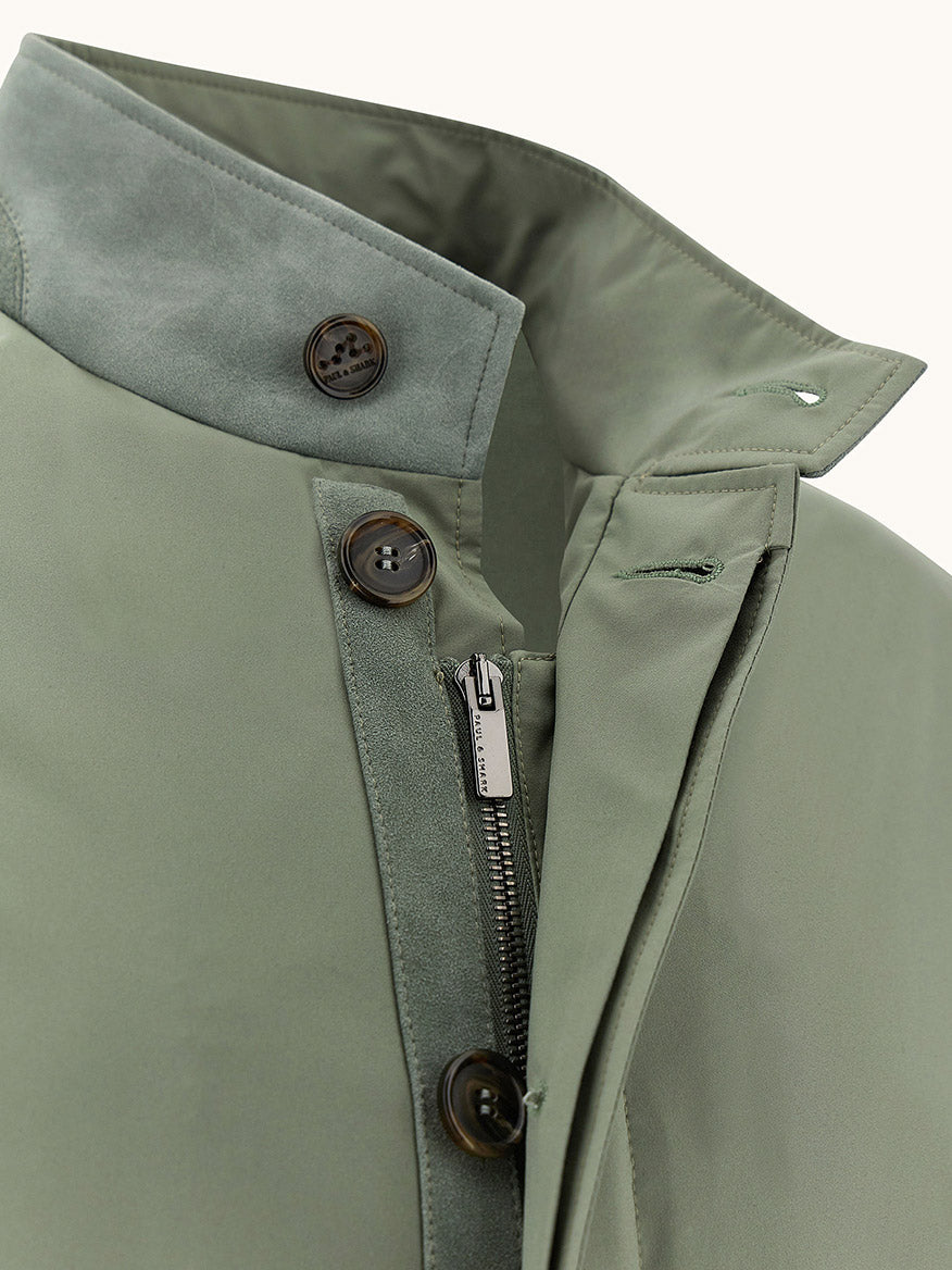 Close-up of the Paul & Shark Typhoon® Platinum Car Coat with Aqualeather suede details in olive, featuring button and zipper closures, a stand collar, and contrasting inner fabric.