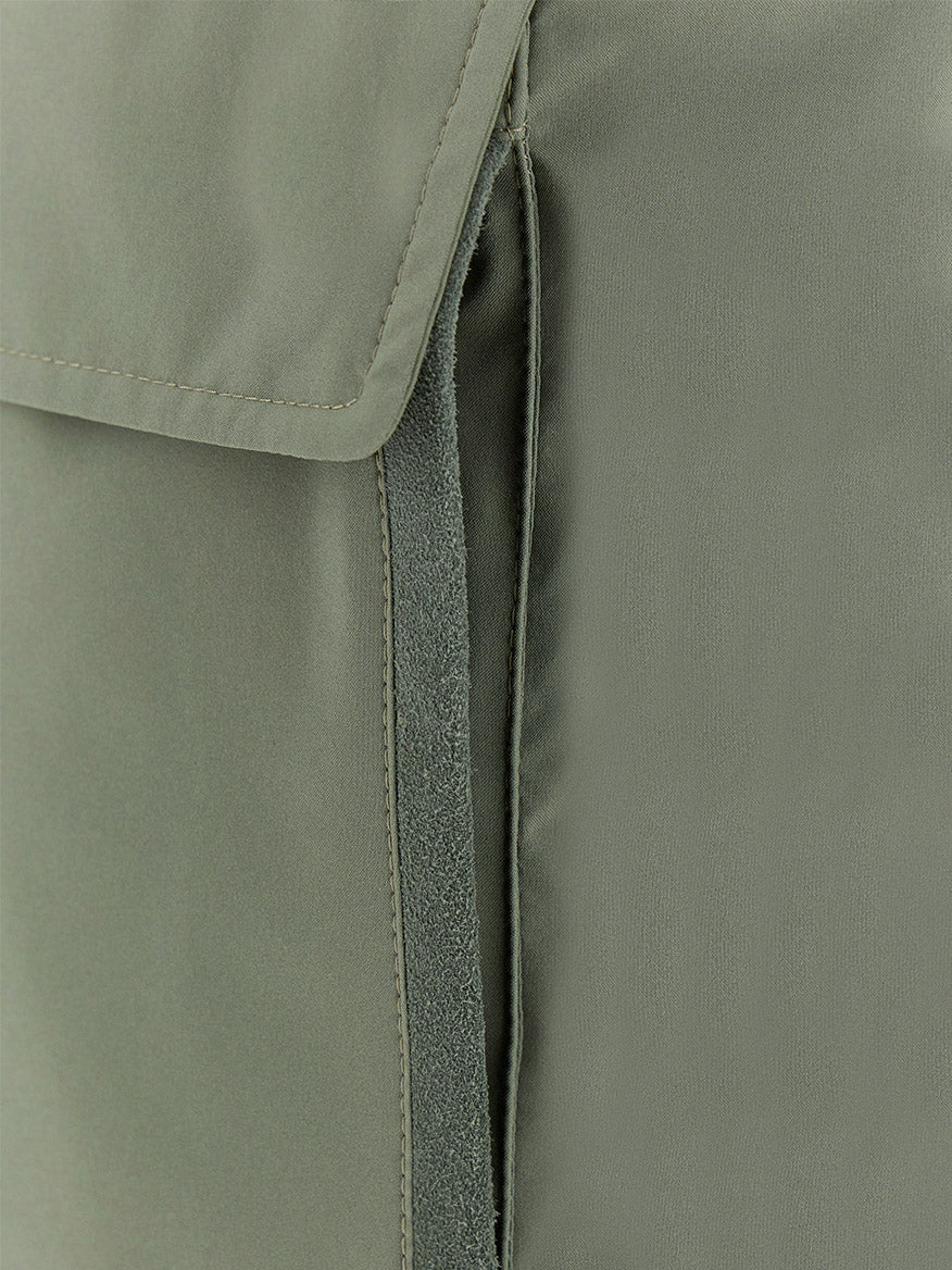 Close-up of the Paul & Shark Typhoon® Platinum Car Coat with Aqualeather suede details in olive, featuring a flap, vertical opening, and visible stitching.