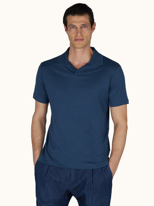 Man wearing a Paul & Shark X-Soft Open‑Collar Polo Shirt in Vintage Indigo with matching pants, standing with hands in pockets against a plain light background.