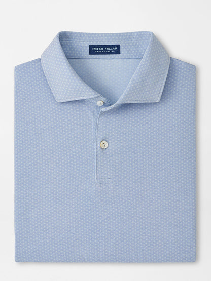 A neatly folded Peter Millar Albatross Diamond Cotton-Blend Piqué Polo in Dusk Blue features a subtle geometric pattern, two white buttons, and a visible brand label inside the collar.
