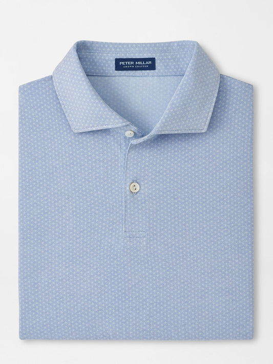 A neatly folded Peter Millar Albatross Diamond Cotton-Blend Piqué Polo in Dusk Blue features a subtle geometric pattern, two white buttons, and a visible brand label inside the collar.