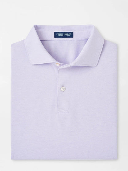 A lavender polo from Peter Millar, called the Albatross Cotton Blend Piqué Polo, neatly folded and made from soft cotton with a buttoned placket.