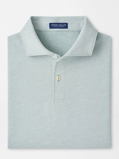 The Peter Millar Albatross Cotton Blend Piqué Polo in Light Willow is neatly folded, featuring a classic collar and two-button placket, made from a comfortable cotton blend fabric.