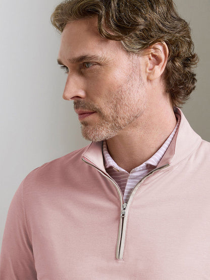 Man with light brown wavy hair and beard wears the Peter Millar Albatross Cotton-Blend Piqué Quarter-Zip in Faded Scarlet over a collared shirt, looking to the side.