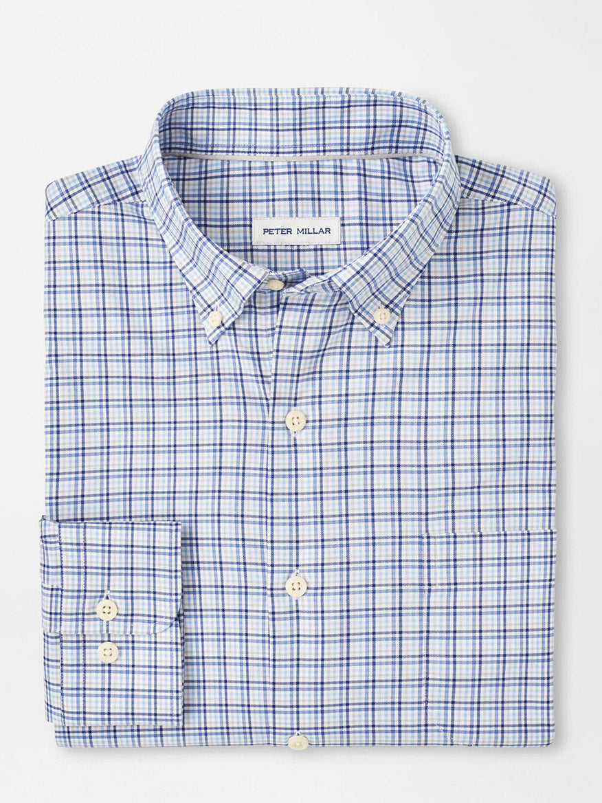 The Peter Millar Albert Crown Lite Cotton-Stretch Sport Shirt in Blue Freesia features a blue and white plaid twill design with a pocket, buttoned collar, and pearl buttons on a white surface. It's crafted from easy-care fabric for a classic fit.