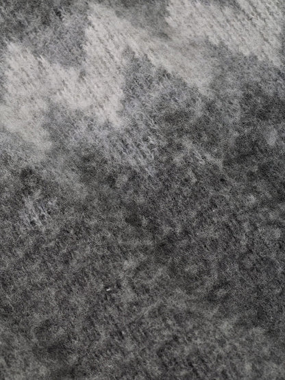 Close-up of a fuzzy Peter Millar Après-Ski Crewneck Sweater in Fossil, featuring an abstract pattern of dark and light gray knit fabric.