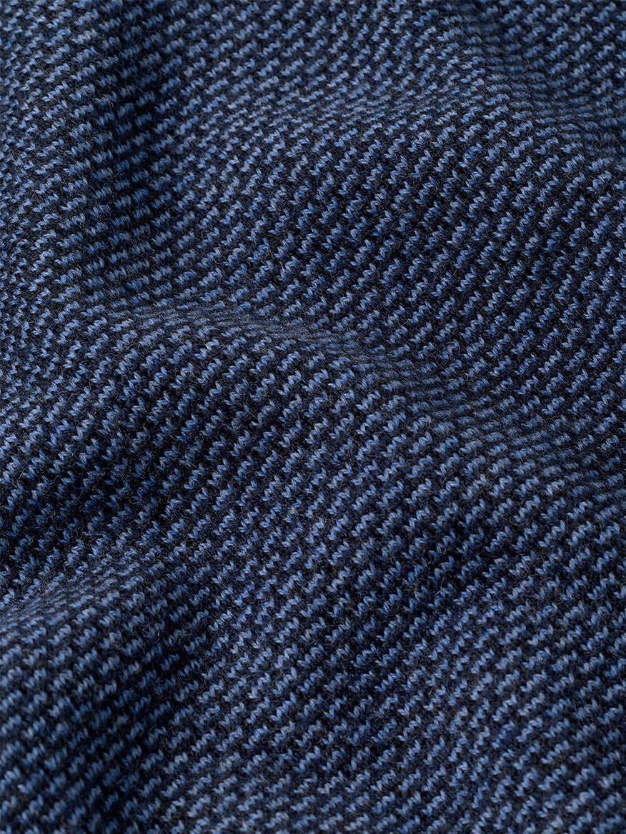 Close-up of the Peter Millar Ashland Quarter-Zip Sweater in Midnight Navy, featuring a dark blue and black houndstooth jacquard pattern with visible texture and slight folds, perfect for a tailored fit.
