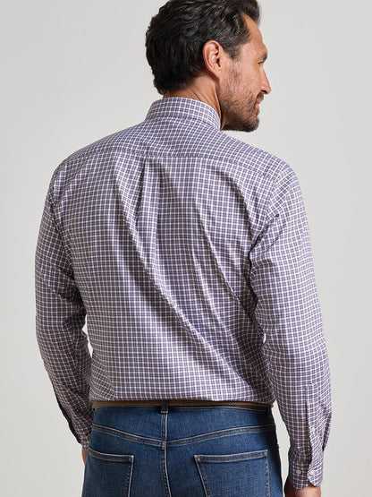 A man facing away, wearing the Peter Millar Atlas Crown Lite Cotton-Stretch Sport Shirt in Grapeseed— a long-sleeve, button-down classic fit shirt crafted from easy-care fabric—paired with blue jeans against a plain background.