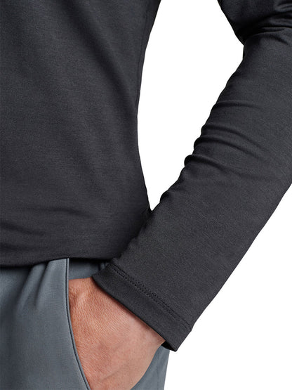 Close-up of a person wearing a Peter Millar Aurora Performance Long-Sleeve T-Shirt in Black made from performance yarn and gray pants with UPF 50+ sun protection.