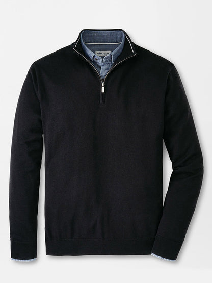 Peter Millar Autumn Crest Quarter-Zip in Black stylishly layered over a visible blue collared shirt, displayed on a crisp white background.