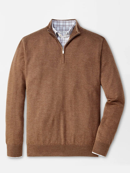 Peter Millar Autumn Crest Quarter-Zip in British Tan layered over a blue plaid button-up shirt on a plain background.