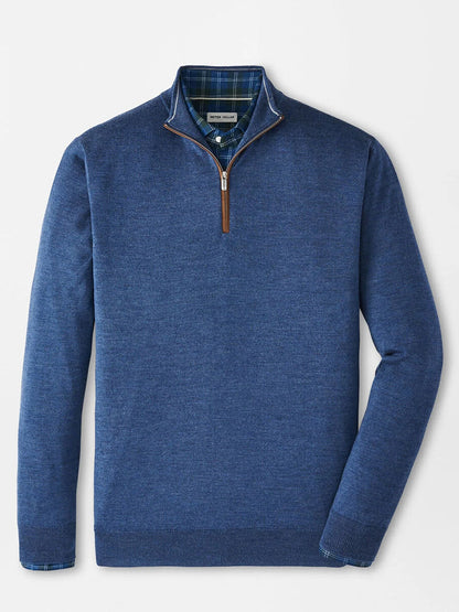 The Peter Millar Autumn Crest Suede Trim Quarter-Zip in Blue Haze, featuring a brown zipper pull, is layered over a blue and green plaid collared shirt and displayed on a plain white background. Classic fit adds versatile style.