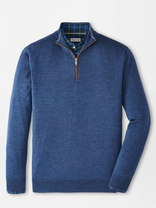 The Peter Millar Autumn Crest Suede Trim Quarter-Zip in Blue Haze, featuring a brown zipper pull, is layered over a blue and green plaid collared shirt and displayed on a plain white background. Classic fit adds versatile style.