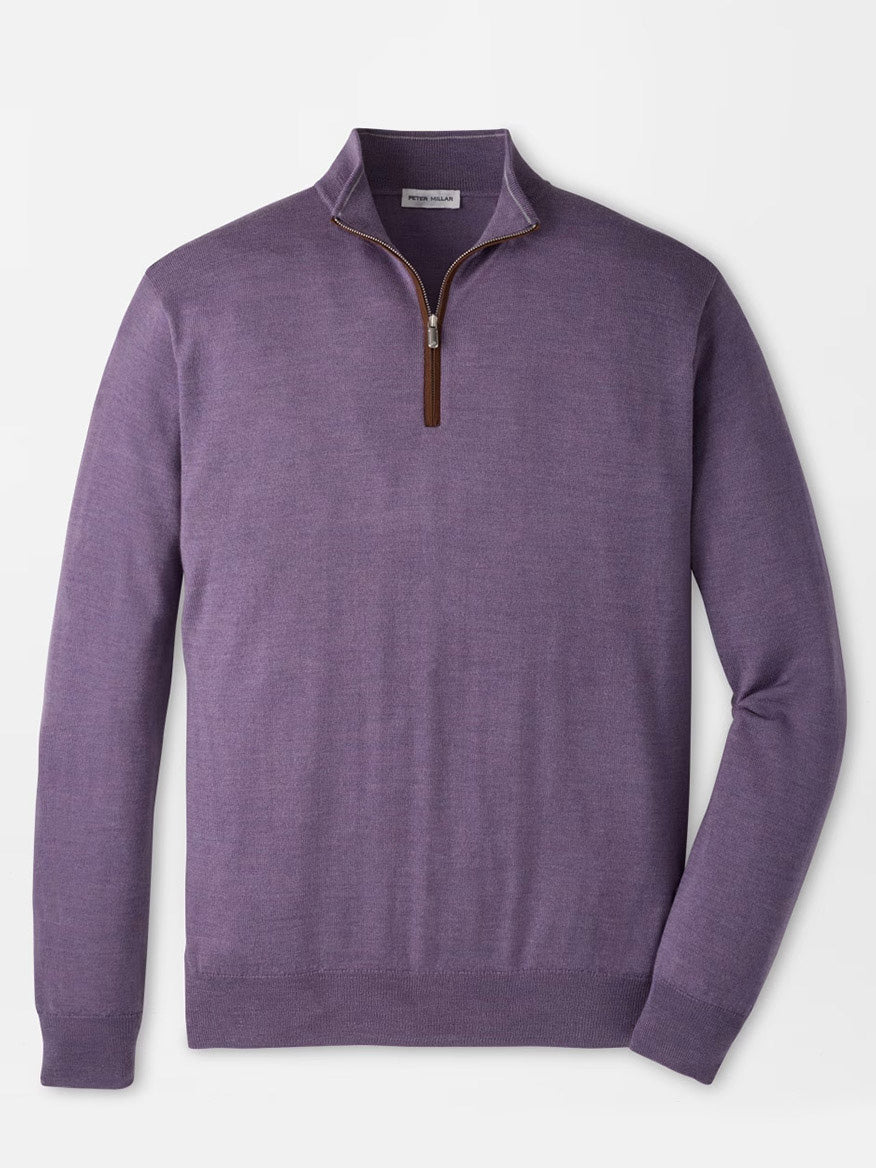 The Peter Millar Autumn Crest Suede Trim Quarter-Zip in Purple Fig is showcased against a plain white background. This long-sleeve sweater features a small collar, brown zipper pull, and is crafted from soft Merino lyocell for a lightweight feel. Offering a classic fit, it seamlessly blends comfort with timeless style.