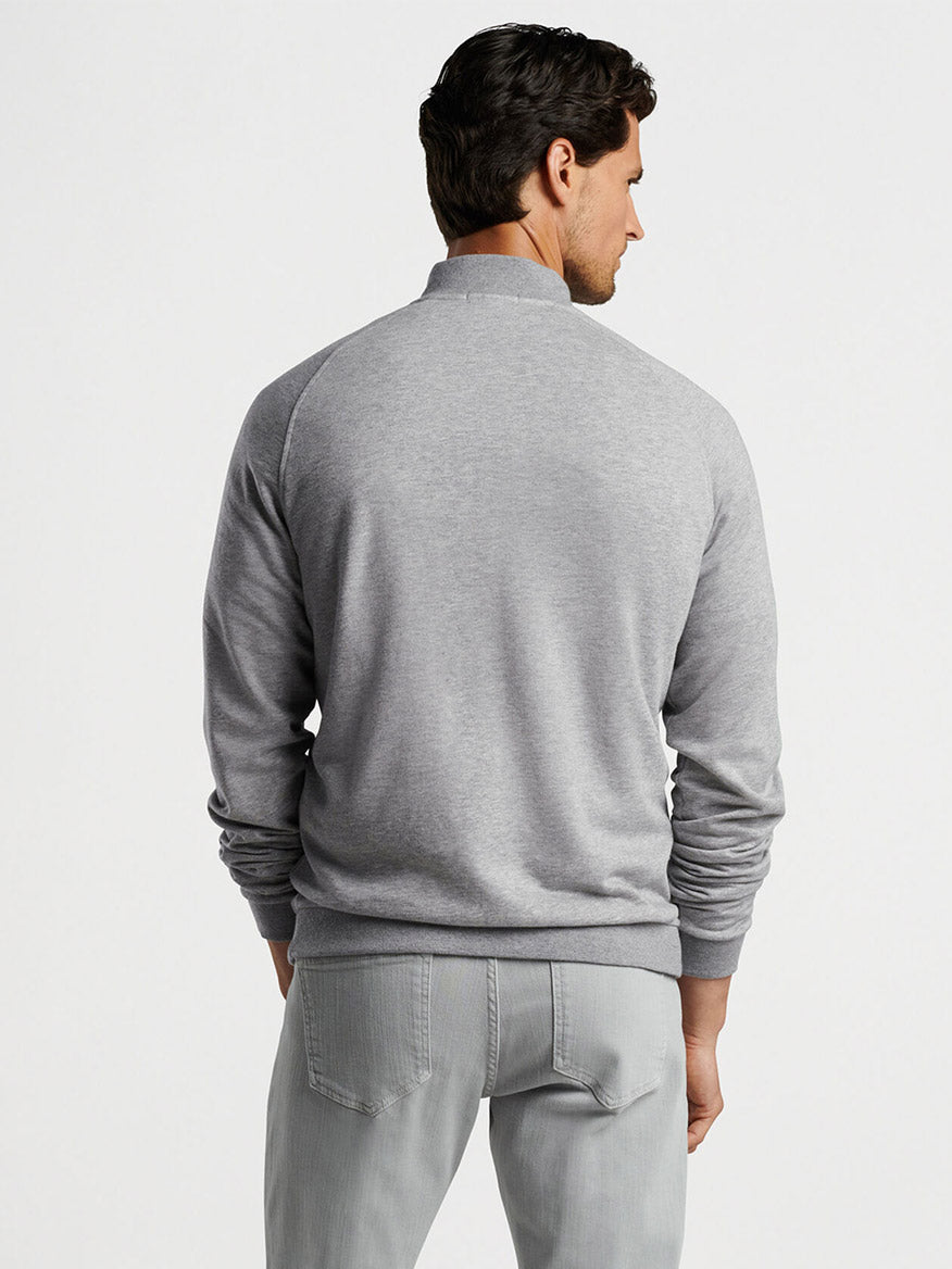 The cool back view of a man wearing the Peter Millar Baldwin Button Front Knit Jacket in British Grey.