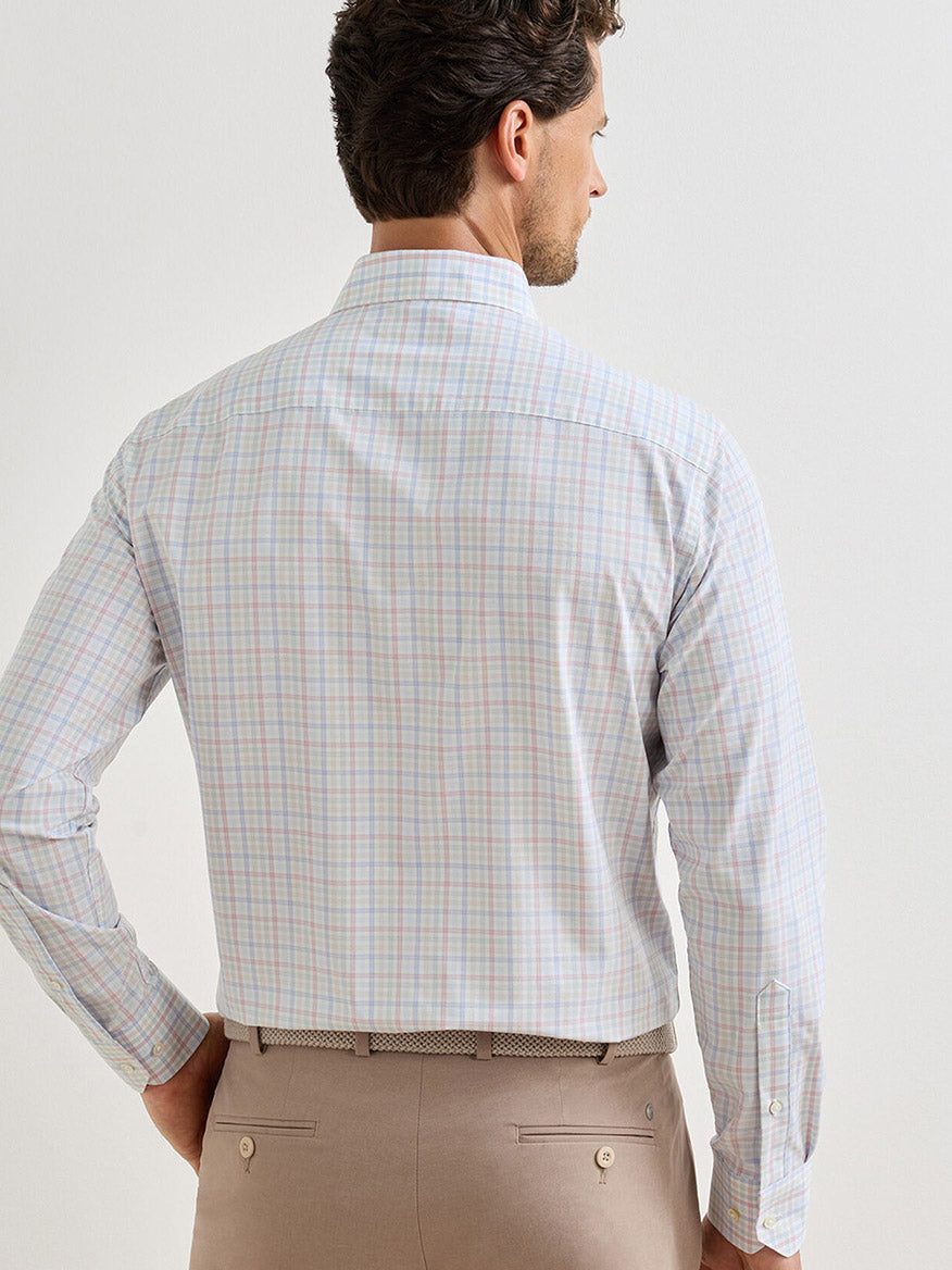 A man is shown from the back against a plain background wearing a Peter Millar Basin Performance Poplin Sport Shirt in Multi with UPF 50+ protection and beige trousers.