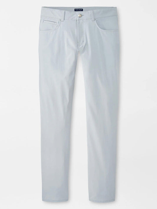 The Peter Millar Bingham Performance Five-Pocket Pant in British Grey features a slim fit, high-performance four-way stretch fabric, and front and back pockets, shown against a white background.
