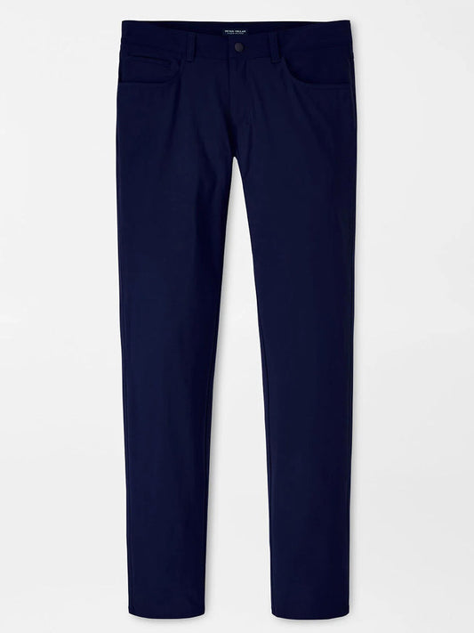 The Peter Millar Bingham Performance Five-Pocket Pant in Navy is a slim-fit style made from lightweight Italian knit fabric, with front and back pockets, shown against a plain white background.