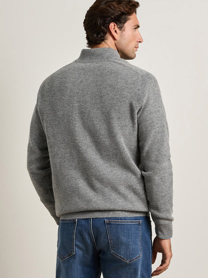 Man seen from the back wearing a Peter Millar Blackburn Button-Mock Sweater in Oslo Grey with blue jeans.