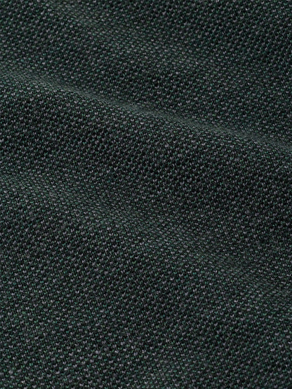 Close-up of a dark green Peter Millar Blair Birdseye Quarter-Zip Sweater in Pine Brook, featuring a finely textured birdseye stitch pattern.