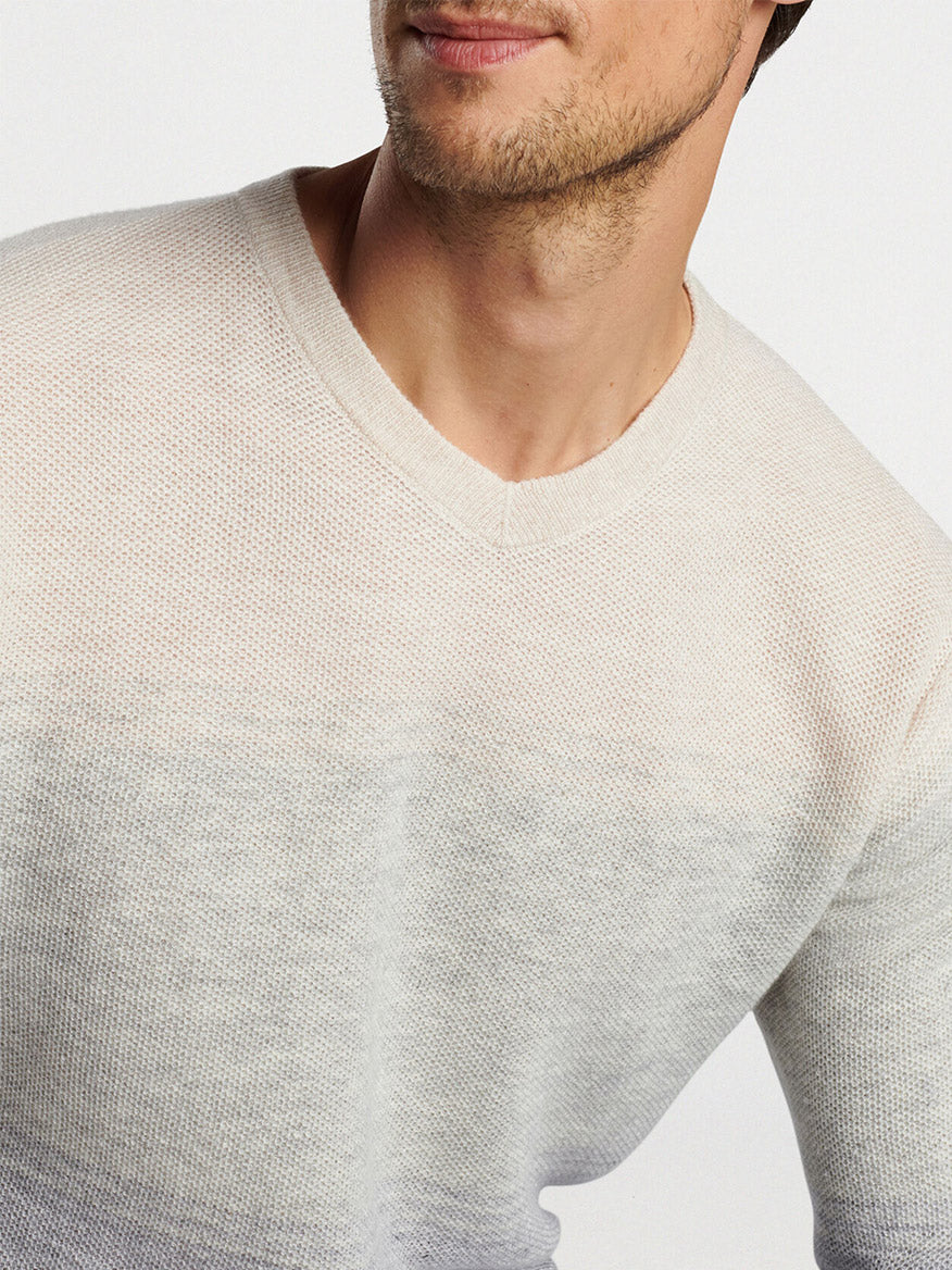 Close-up of a man wearing a Peter Millar Camden High V Striped Sweater in British Grey, focusing on the upper chest and neck area.