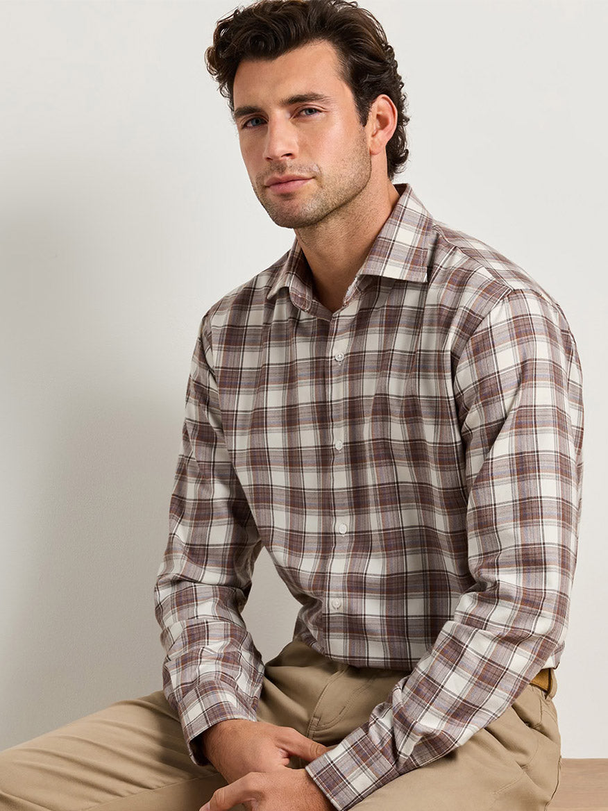 A man wearing a Peter Millar Cannon Performance Flannel Sport Shirt in Winter Ivory with tan pants.