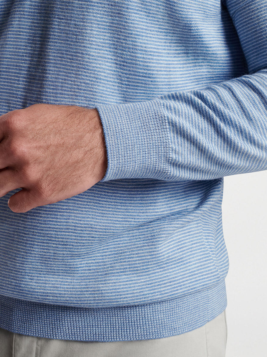 Close-up of a man's torso wearing a Peter Millar Canton Stripe Quarter-Zip Sweater in Cottage Blue, with focus on the fabric and his hand resting on his hip.