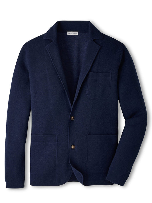 The Peter Millar Carson Sweater Blazer in Navy is a blazer-style cardigan crafted with a refined interlock stitch at a 14 GG gauge, featuring a notched lapel, two front pockets, one chest pocket, and two front buttons.