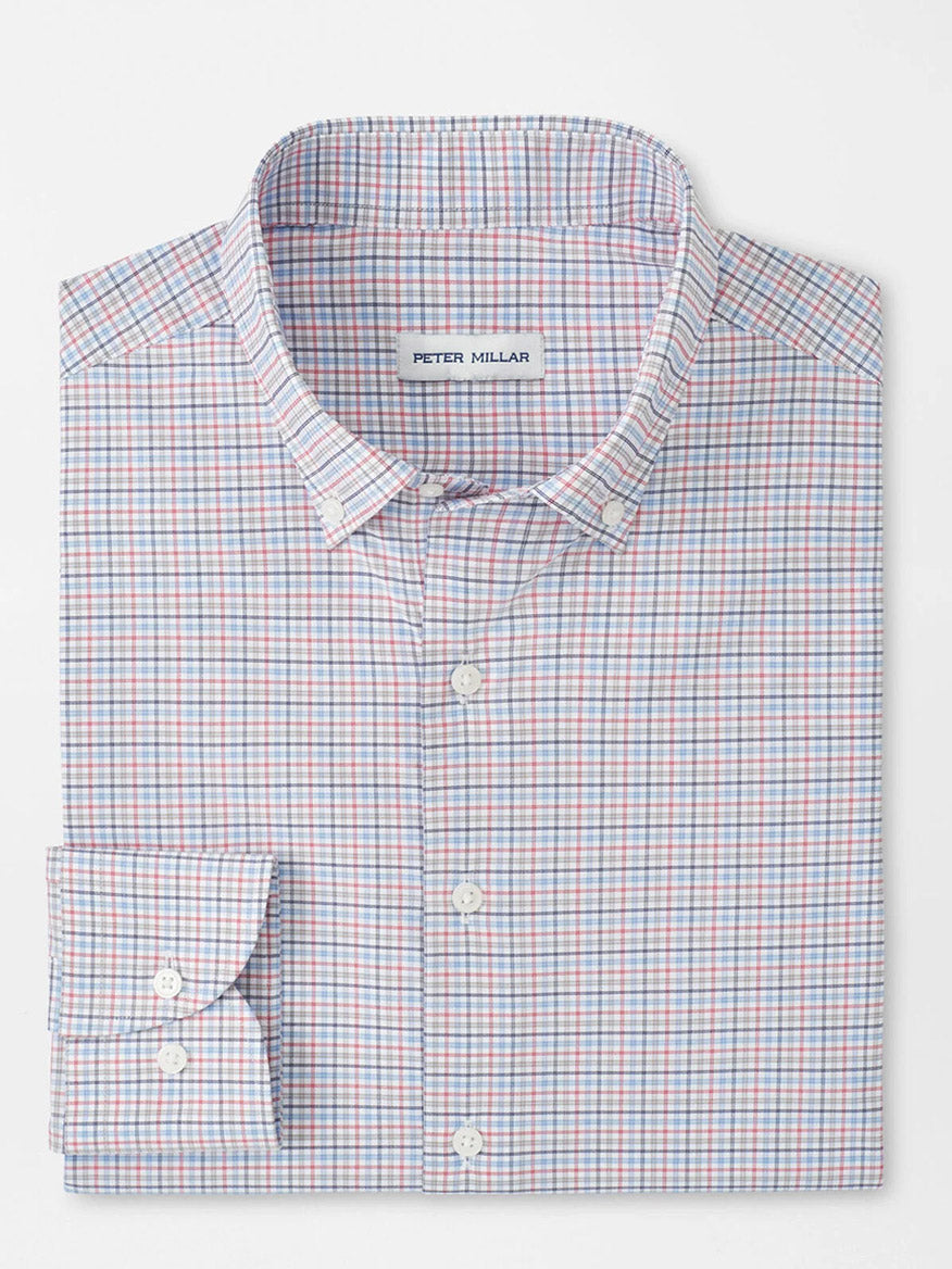 A folded Peter Millar Casey Performance Twill Sport Shirt in Navy features a small red, blue, and white checkered pattern and is crafted from performance fabric for all-day comfort.