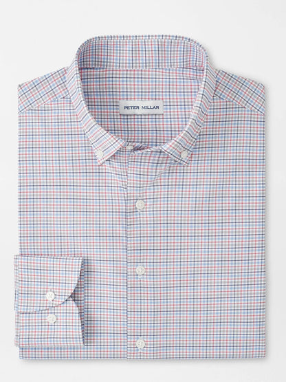 A folded Peter Millar Casey Performance Twill Sport Shirt in Navy features a small red, blue, and white checkered pattern and is crafted from performance fabric for all-day comfort.