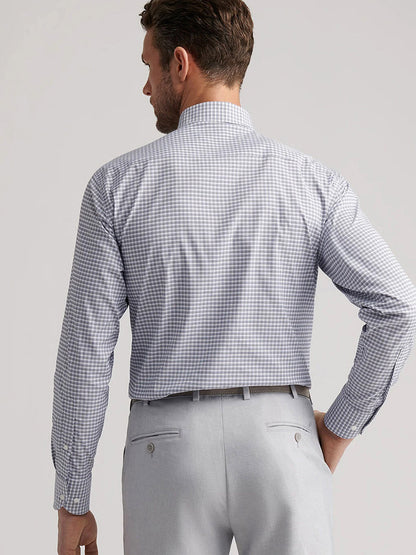 A man is shown from the back wearing a Peter Millar Cashiers Performance Twill Sport Shirt in Oslo Grey and light gray dress pants.