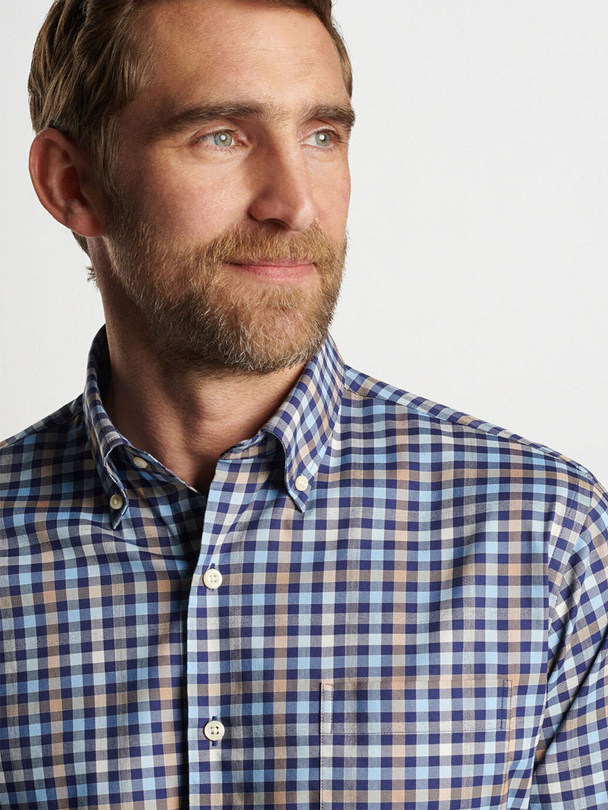 A bearded man in a Peter Millar Chambly Crown Lite Cotton-Stretch Sport Shirt in Navy gazes slightly to the side, set against a plain background.