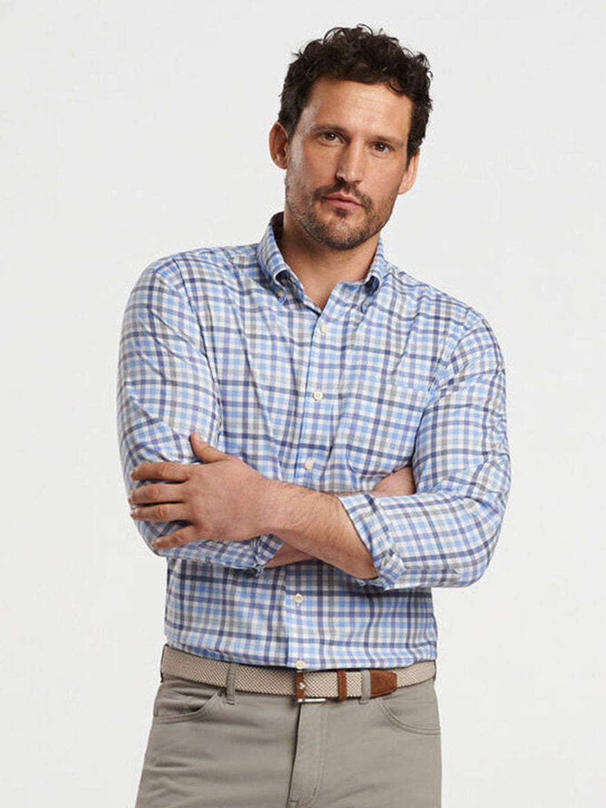 A man with short dark hair and a beard wears the Peter Millar Chambly Crown Lite Cotton-Stretch Sport Shirt in White, standing with arms crossed against a plain background.