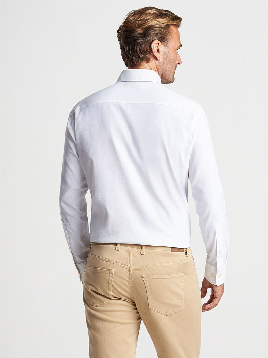 Man wearing a Peter Millar Collins Performance Oxford Sport Shirt in White and beige pants, viewed from the back.