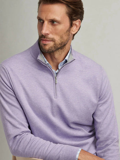 A man with short brown hair wears a Peter Millar Coolspun Cotton Quarter-Zip Sweater in Wildflower over a blue collared shirt, looking sideways against a plain background.