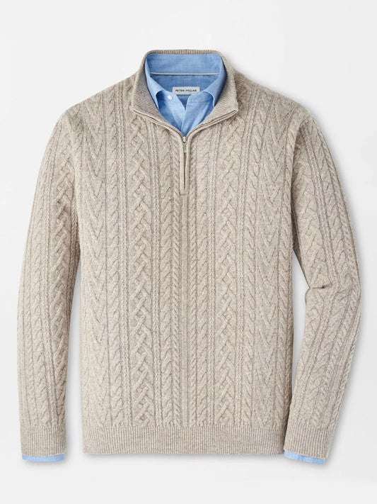 The Peter Millar Crescent Ridge Cable Quarter-Zip Sweater in Light Elm, crafted from blended wool yarn, is styled over a light blue collared shirt and laid flat on a white background.