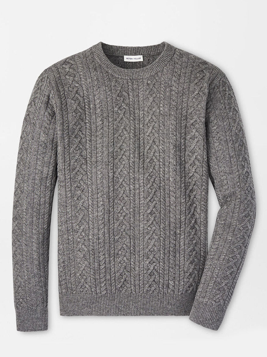 The Peter Millar Crescent Ridge Cable Crew in Gale Grey, a sweater made from soft Merino wool, is displayed flat against a white background, highlighting its cozy design ideal for three-season wear.