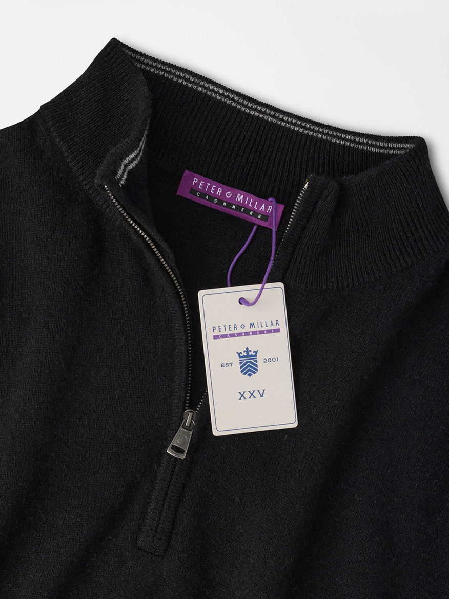 Black Peter Millar 25th Anniversary Cashmere Quarter-Zip Sweater with a branded tag attached to the zipper pull.
