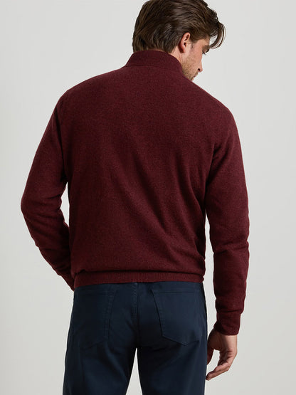 Back view of a person wearing a Peter Millar 25th Anniversary Cashmere Quarter-Zip Sweater in Bordeaux and dark trousers.