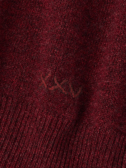 Close-up of a Peter Millar 25th Anniversary Cashmere Quarter-Zip Sweater in Bordeaux, featuring embroidered stitching detail on the burgundy cashmere fabric.