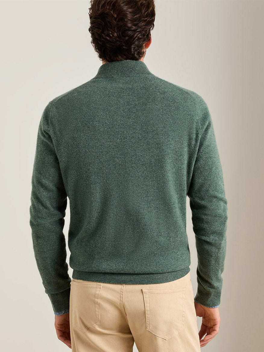 A person seen from behind wearing an Ivy Peter Millar 25th Anniversary Cashmere Quarter-Zip Sweater and tan pants.