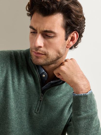 Man wearing a Peter Millar 25th Anniversary Cashmere Quarter-Zip Sweater in Ivy over a collared shirt.