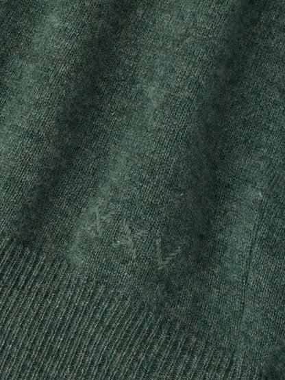 Close-up of a Peter Millar 25th Anniversary Cashmere Quarter-Zip Sweater in Ivy, featuring a tonal Roman numeral XXV embroidered on the chest.
